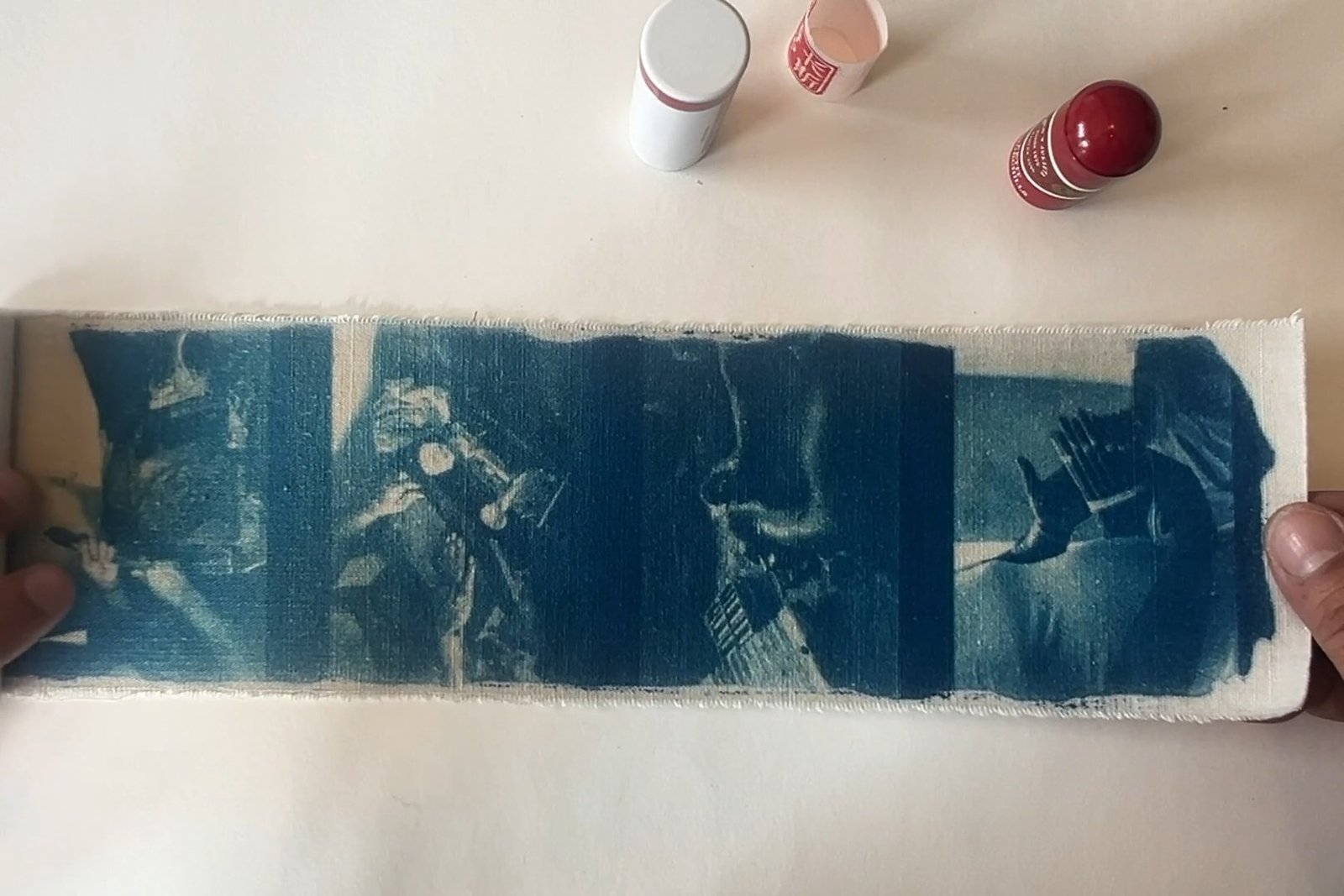 The book unrolled — cyanotype on a single strip of cotton